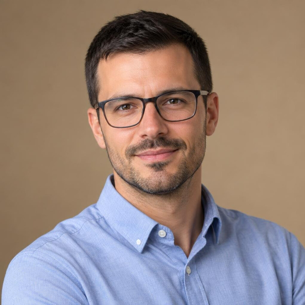 Studio portrait of a man in glasses and a business casual shirt